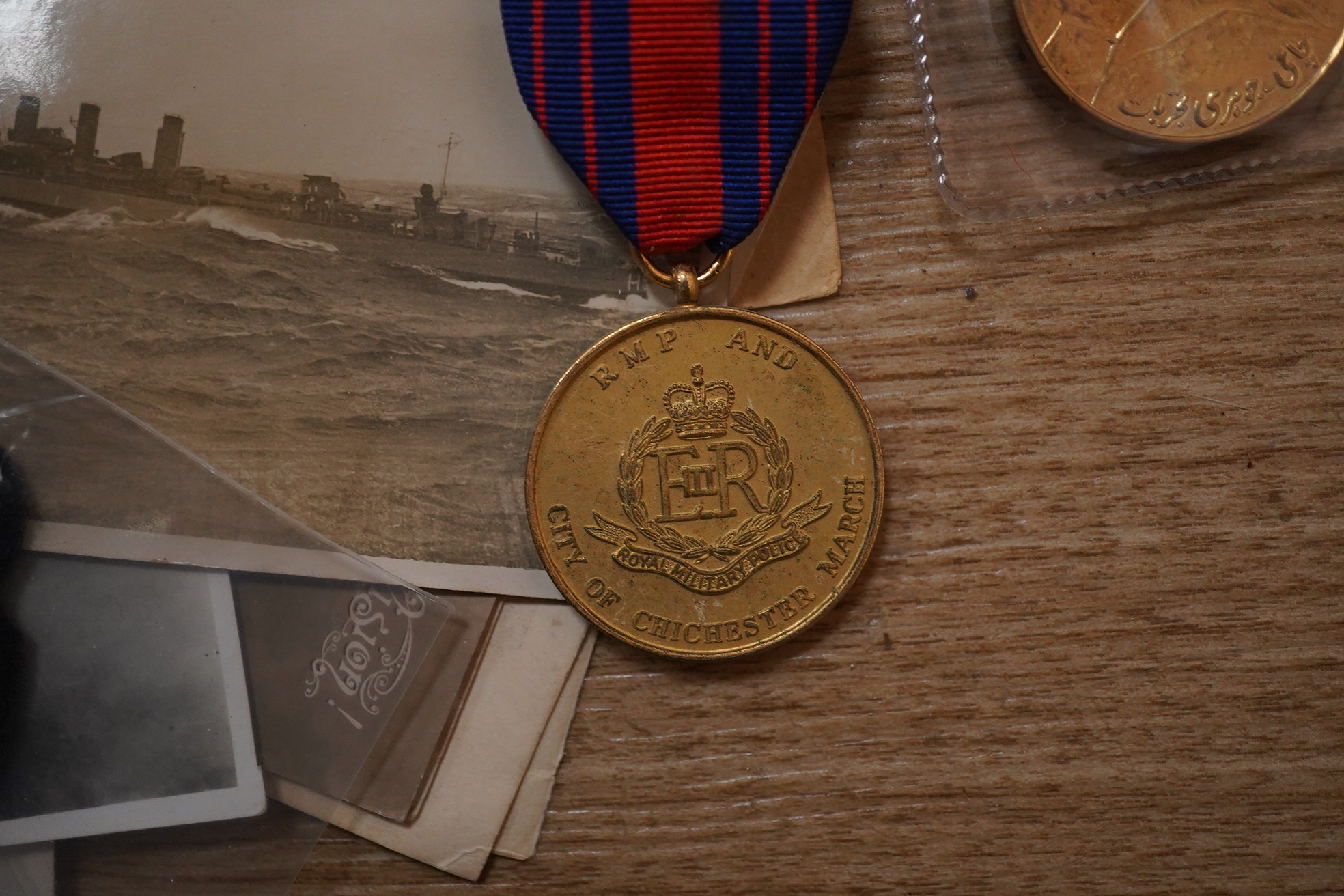 A quantity of various military ephemera to include a Coldstream guards matchbox holder, a death plaque and another 19th century glass plaque, buttons, badges, National Registration Identity Card, various photos and lette